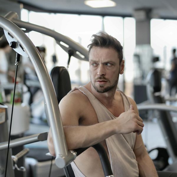 Focused man performing a core strength exercise in a bright, modern space.